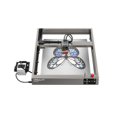 A top view of the Creality Falcon Falcon2 22W Diode Laser Engraver etching a blue and black butterfly design onto metal, highlighting its powerful cutting performance and vivid color engraving abilities.